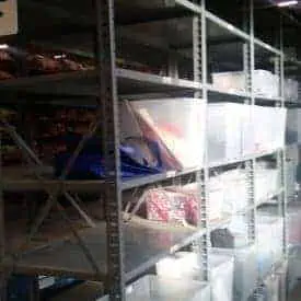 Gray nut & bolt steel shelving side view in a warehouse