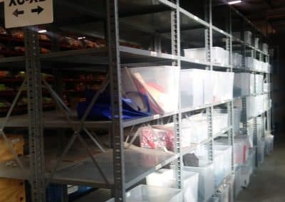 Gray nut & bolt steel shelving side view in a warehouse
