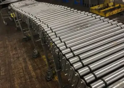 Used NestaFlex power roller conveyor in warehouse