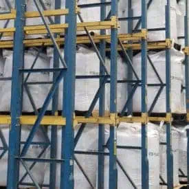 Blue and yellow drive-in pallet rack in distribution center
